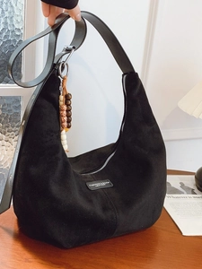 Retro black suede hobo shoulder bag with a crescent shape and colorful bead charm
