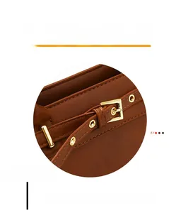Detailed close-up of brown PU leather handbag with reinforced stitching and gold buckles