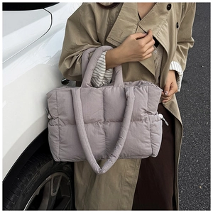 Close-up of lilac quilted nylon puffer tote bag with soft padded handle detail