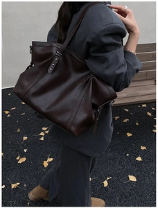 Détail du grand sac cabas marron avec rivets en étoile et texture en cuir PU de qualité