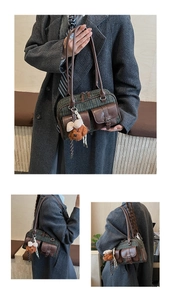 Detail of vintage plaid Boston bag with leather pockets and cute puppy pendant accessory