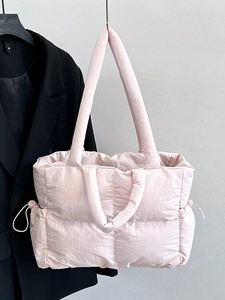 Quilted nylon tote bag in light pink with padded shoulder straps and drawstring details