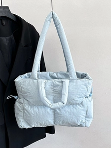 Light blue quilted nylon tote bag with dual straps and side drawstrings for women