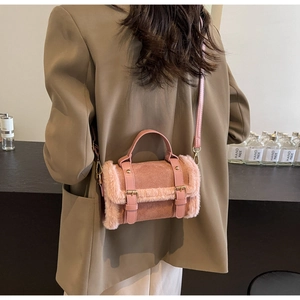 Pink plush shoulder bag detail showing faux fur trim and suede material on brown blazer