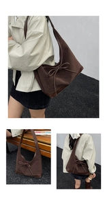Detail view of coffee brown suede tote bag with bow tie and smooth leather stitching