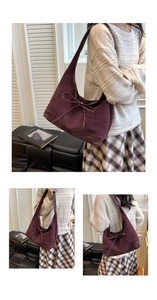 Macro detail of wine red suede hobo bag featuring decorative bow and soft texture