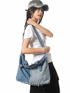 Vintage patchwork denim tote bag with frayed edges and wide shoulder strap