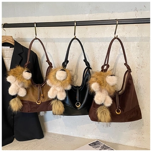 Three leather and suede tote bags in various colors featuring cute lion plush charms