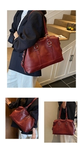 Detail view of large dark red PU leather tote bag with silver rings and zip closure