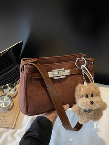 Brown suede underarm bag with silver turn-lock and cute plush dog charm accessory