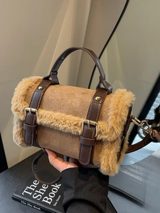 Brown faux fur patchwork shoulder bag with leather strap and gold buckle in warm setting