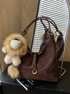 Brown suede tote bag with brass rings and lion plush pendant for autumn winter outfits