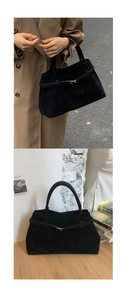 Gros plan sur le sac fourre-tout en daim noir avec boucle élégante et style rétro