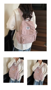 Detail of pink drawstring backpack featuring large capacity and stylish cloth label