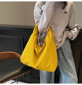 Detail of a bright yellow oversized tote bag made of soft fabric for casual daily use