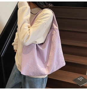 Detail of light purple large tote bag with crinkled texture on wooden stairs