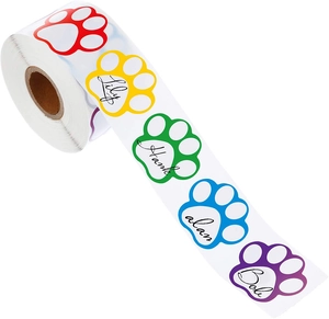 Close-up of colorful paw-shaped self-adhesive labels on a roll for pet name identification