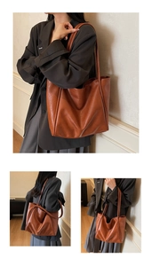 Detailed view of a brown soft faux leather tote bag with elegant slim shoulder straps