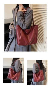 Detail view of a spacious burgundy tote bag showing soft texture and long handles