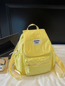 Yellow casual laptop backpack with flap cover and front pocket for daily commute