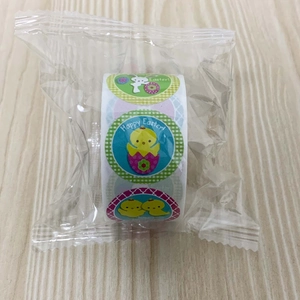 Close-up of Easter roll stickers with cartoon rabbit and chick designs on wood background
