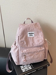 Pinkish purple nylon backpack with flap closure and minimalist square patch detail