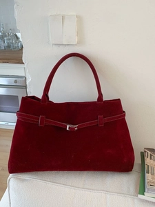 Sac fourre-tout rétro en cuir dépoli bordeaux avec boucle élégante sur canapé