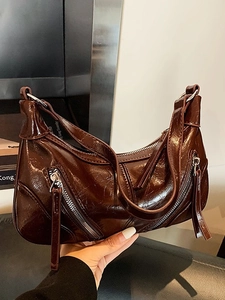 Vintage dark brown faux leather underarm bag with zipper details and glossy texture