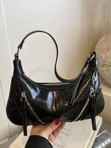 Vintage black faux leather hobo bag with glossy finish and silver hardware details