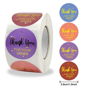 Roll of 1.5 inch multi-colored Thank You stickers with gold foil lettering for packaging