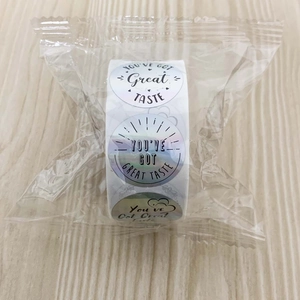 Macro view of multi-color holographic stickers with You Have Got Great Taste text in a roll
