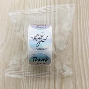 Macro detail of holographic gradient Thank You stickers for small business packaging