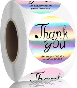 Close-up of circular holographic Thank You stickers on a roll with iridescent finish