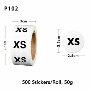 Detail showing 2.5cm diameter XS clothing size labels on a 500-sticker adhesive roll