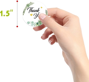 Detail of 1.5 inch round thank you stickers with green leaves and succulent designs