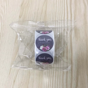 Detail view of floral thank you sticker roll in transparent protective packaging