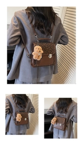 Detail view of retro leopard print backpack with brown leather and bear charm