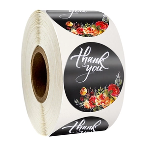 Roll of round black Thank You stickers with floral design for gift packaging and envelopes