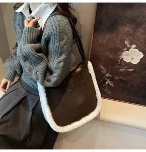 Detail showing deep brown suede tote with faux shearling trim and snap button pocket