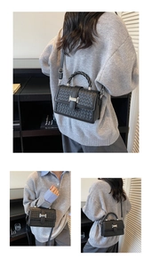 Détail du sac bandoulière noir tissé avec boucle argentée et poignée torsadée