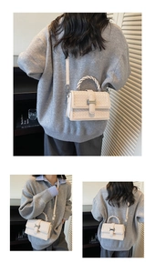 Détail de la texture tressée et boucle en H sur le sac à bandoulière blanc cassé