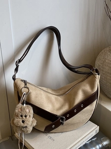 Large leopard-accented crescent shoulder bag in khaki faux leather with plush charm