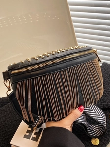 Fashionable black faux leather saddle bag with gold tassels and wide shoulder strap