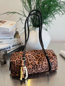 Vintage leopard print barrel bag with black leather shoulder strap and colorful bead tassel