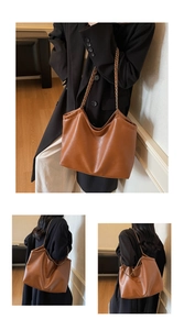 Detail view of brown faux leather tote bag showing fine texture and chain strap