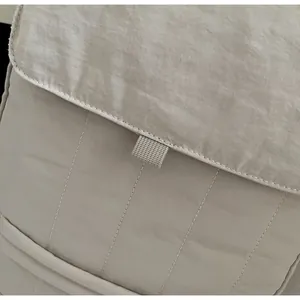 Detail of soft quilted fabric and fine texture on a lightweight tote commuting bag
