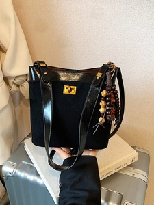 Vintage black suede bucket bag with contrast leather trim and decorative wooden beads