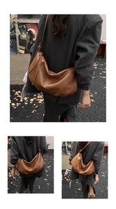 Detail view of large brown slouchy hobo bag with drawstring and adjustable strap