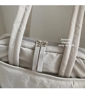 Detailed macro view showing the smooth double-zipper closure and durable fabric handles