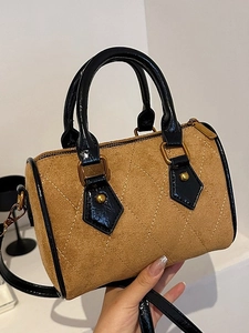 Quilted faux suede Boston bag in tan and black with gold hardware and shoulder strap